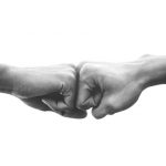 Hands of man people fist bump team teamwork and partnership business success, Black and white image